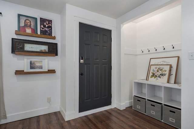 entrance foyer with dark wood finished floors and baseboards