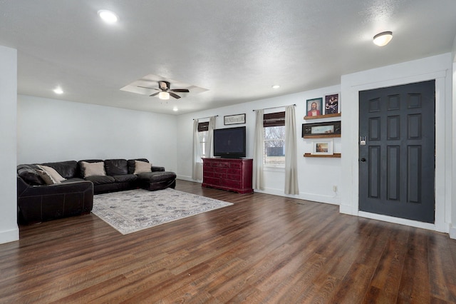 living area featuring recessed lighting, baseboards, dark wood-type flooring, and a ceiling fan