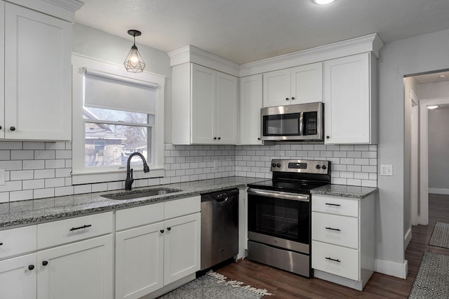 kitchen with dark wood-style flooring, white cabinets, appliances with stainless steel finishes, and a sink