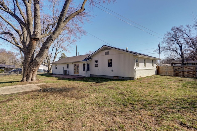 view of front of home with a front yard, fence, crawl space, a patio area, and brick siding