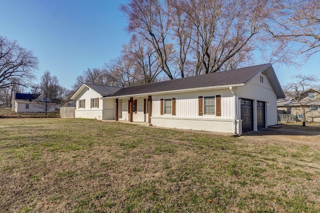 single story home with brick siding, a front lawn, metal roof, and a garage