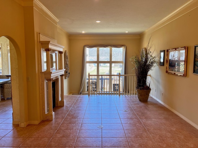 interior space featuring recessed lighting, baseboards, arched walkways, and ornamental molding