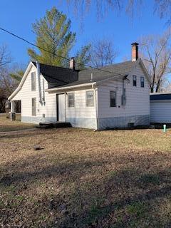 view of side of home featuring a chimney