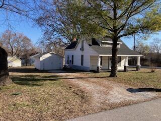 view of property exterior with a storage shed and an outdoor structure