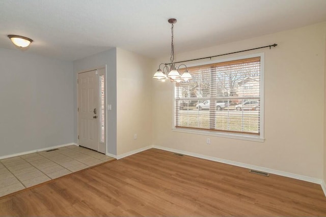 175 Mesquite Dr, Branson, MO 65616 - spare room with visible vents, baseboards, light wood-type flooring, and an inviting chandelier