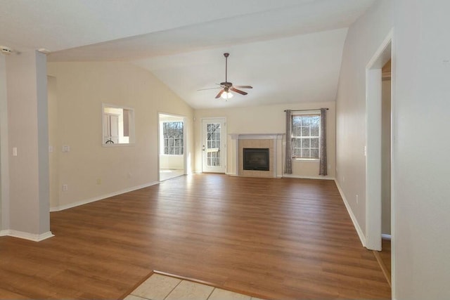 175 Mesquite Dr, Branson, MO 65616 - unfurnished living room featuring wood finished floors, baseboards, lofted ceiling, ceiling fan, and a tile fireplace