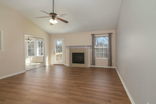175 Mesquite Dr, Branson, MO 65616 - unfurnished living room featuring lofted ceiling, a healthy amount of sunlight, wood finished floors, and a tile fireplace