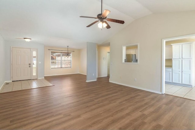 175 Mesquite Dr, Branson, MO 65616 - unfurnished living room with vaulted ceiling, baseboards, a ceiling fan, and wood finished floors