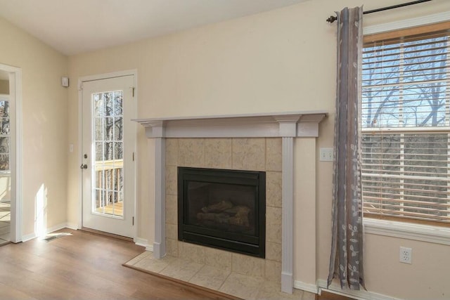 175 Mesquite Dr, Branson, MO 65616 - details with baseboards, wood finished floors, and a tile fireplace