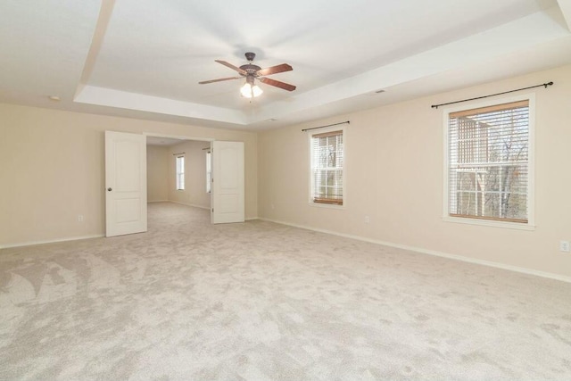 175 Mesquite Dr, Branson, MO 65616 - unfurnished room featuring a tray ceiling, baseboards, and a wealth of natural light
