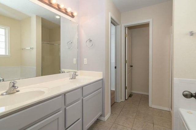 175 Mesquite Dr, Branson, MO 65616 - full bathroom featuring a sink, a tub to relax in, double vanity, and tile patterned floors