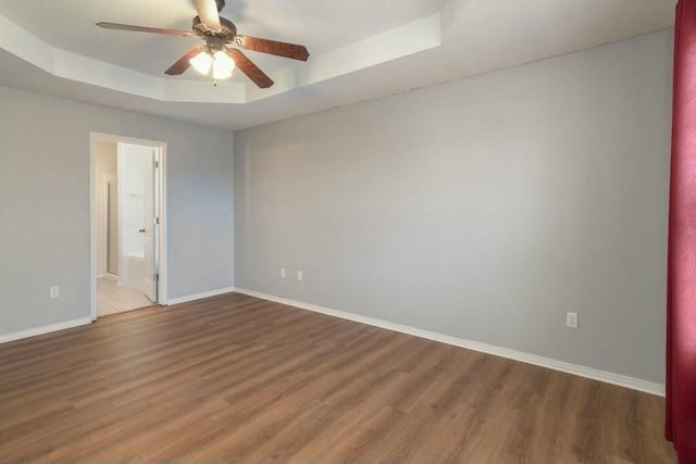 175 Mesquite Dr, Branson, MO 65616 - empty room featuring a ceiling fan, a raised ceiling, wood finished floors, and baseboards