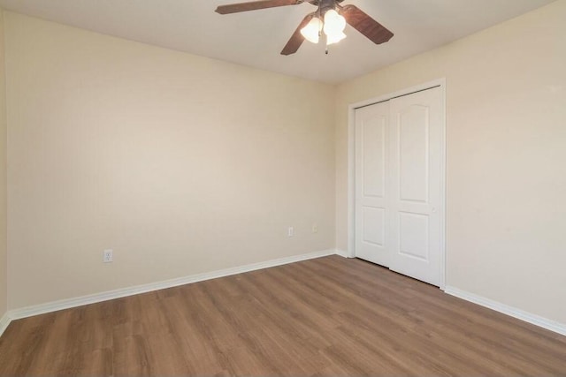 175 Mesquite Dr, Branson, MO 65616 - unfurnished bedroom with a closet, a ceiling fan, baseboards, and wood finished floors
