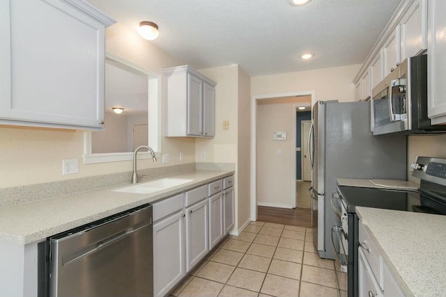 175 Mesquite Dr, Branson, MO 65616 - kitchen with light countertops, light tile patterned flooring, appliances with stainless steel finishes, and a sink