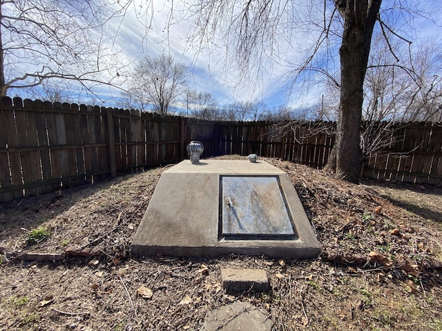 view of storm shelter with a fenced backyard