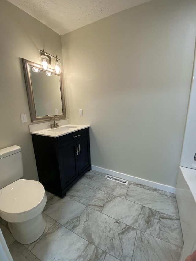 bathroom with visible vents, baseboards, a textured ceiling, toilet, and marble finish floor