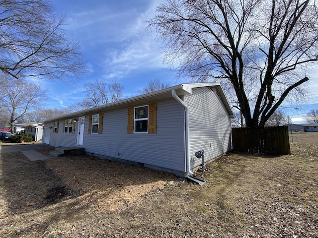 view of front of property featuring crawl space and fence