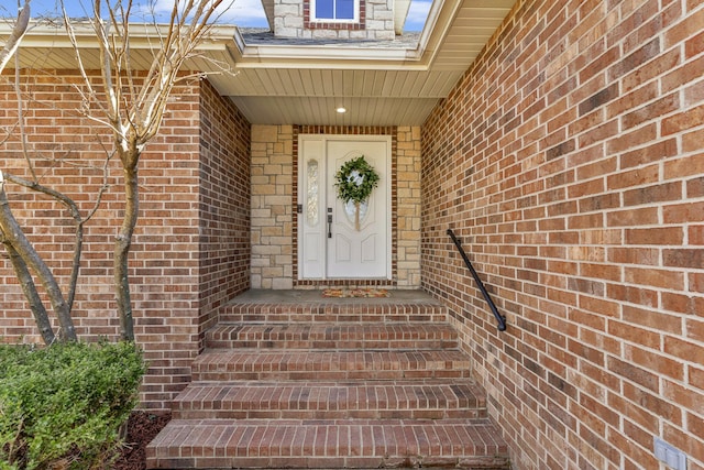 property entrance featuring brick siding