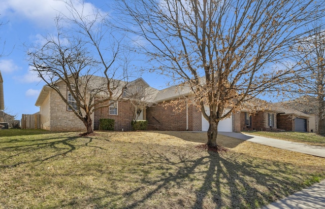 view of front of property featuring brick siding, an attached garage, fence, a front yard, and driveway