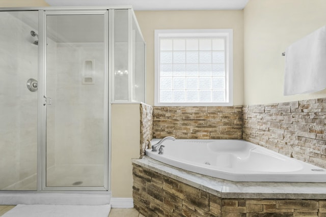 bathroom featuring a shower stall and a garden tub