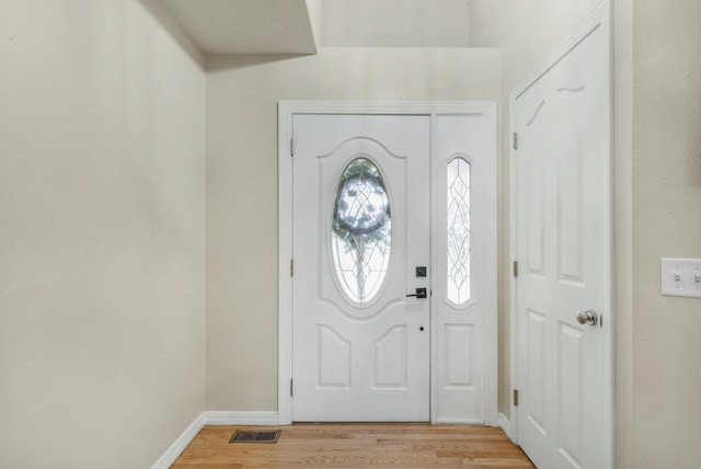 entrance foyer featuring light wood finished floors, visible vents, and baseboards