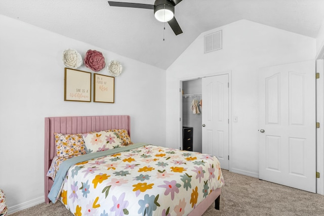 carpeted bedroom featuring a closet, visible vents, ceiling fan, and lofted ceiling