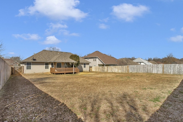 view of yard featuring a wooden deck and a fenced backyard