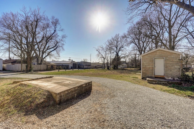 view of yard with an outdoor structure and fence