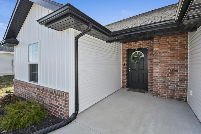 view of exterior entry with brick siding