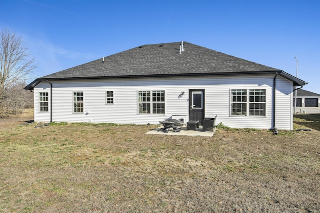 back of property featuring a yard, a patio, a fire pit, and a shingled roof