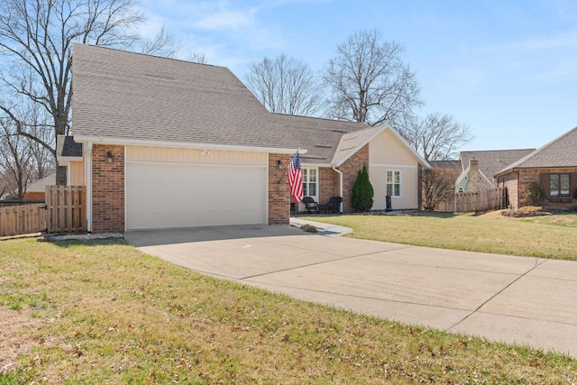 view of front of property with brick siding, fence, a front yard, a garage, and driveway