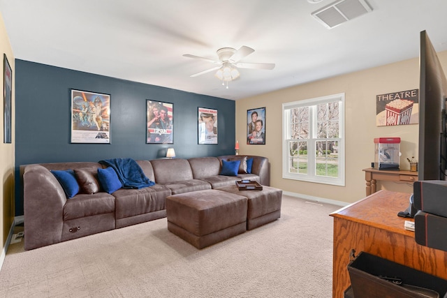 carpeted living room with visible vents, baseboards, and ceiling fan