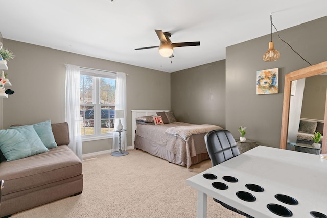 carpeted bedroom featuring a ceiling fan and baseboards