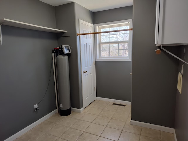 laundry room with light tile patterned floors, visible vents, and baseboards