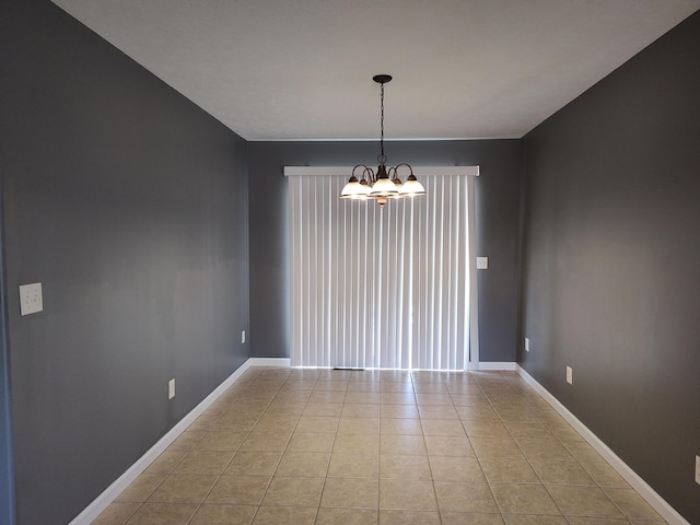 unfurnished room featuring light tile patterned floors, baseboards, and an inviting chandelier