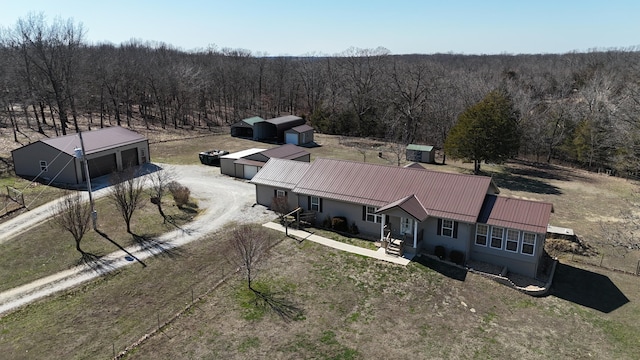 birds eye view of property with a forest view