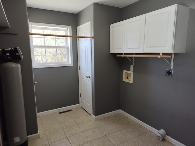 washroom featuring electric dryer hookup, baseboards, cabinet space, and hookup for a washing machine