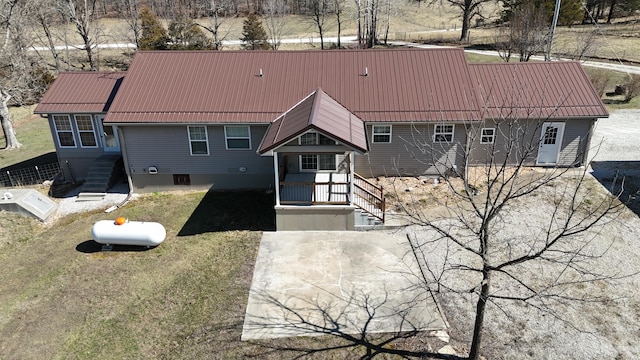 rear view of property featuring metal roof