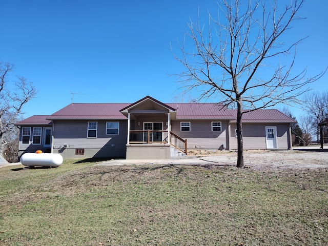 view of front of property with metal roof and a front yard