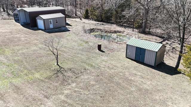 view of yard featuring a storage shed and an outbuilding