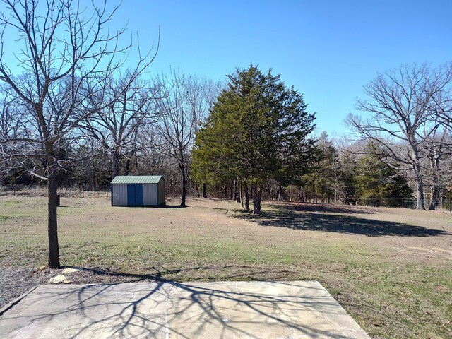 view of yard with an outbuilding and a shed