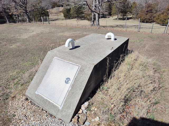 view of storm shelter featuring fence