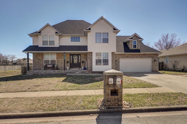 traditional-style home featuring a shingled roof, a front lawn, concrete driveway, covered porch, and an attached garage