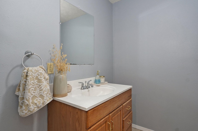 bathroom with baseboards and vanity