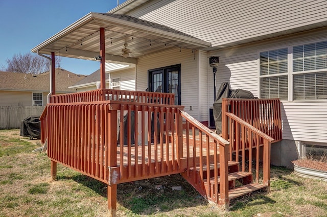 wooden terrace with a yard, fence, and ceiling fan