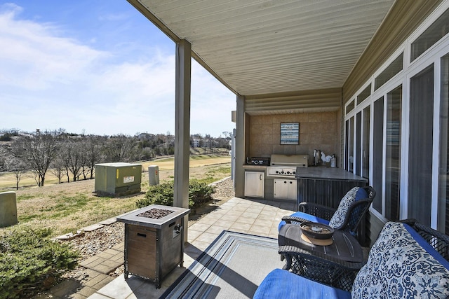 view of patio / terrace featuring an outdoor kitchen, a fire pit, and grilling area