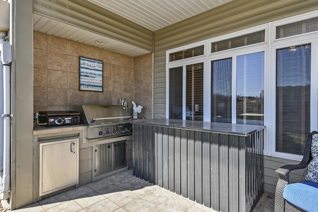 view of patio / terrace featuring an outdoor kitchen and a grill