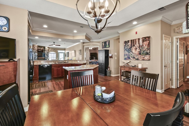 dining space with recessed lighting, a tray ceiling, dark wood finished floors, and ceiling fan with notable chandelier