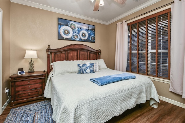 bedroom with crown molding, wood finished floors, baseboards, and ceiling fan