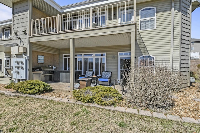 rear view of house featuring a balcony